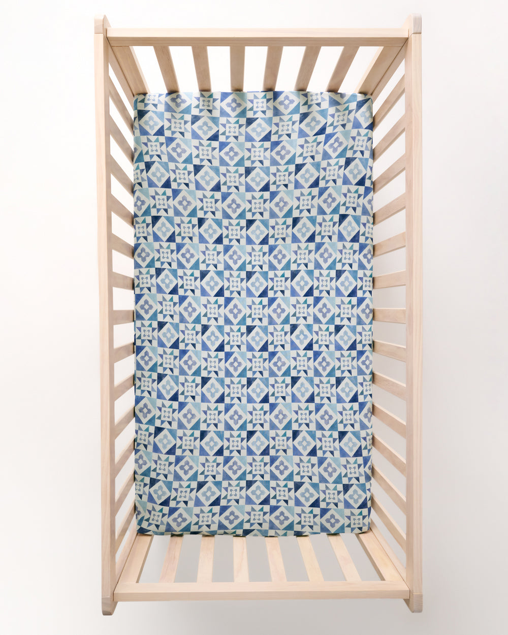 Overhead view of the Patchwork Indigo Fitted Crib Sheet