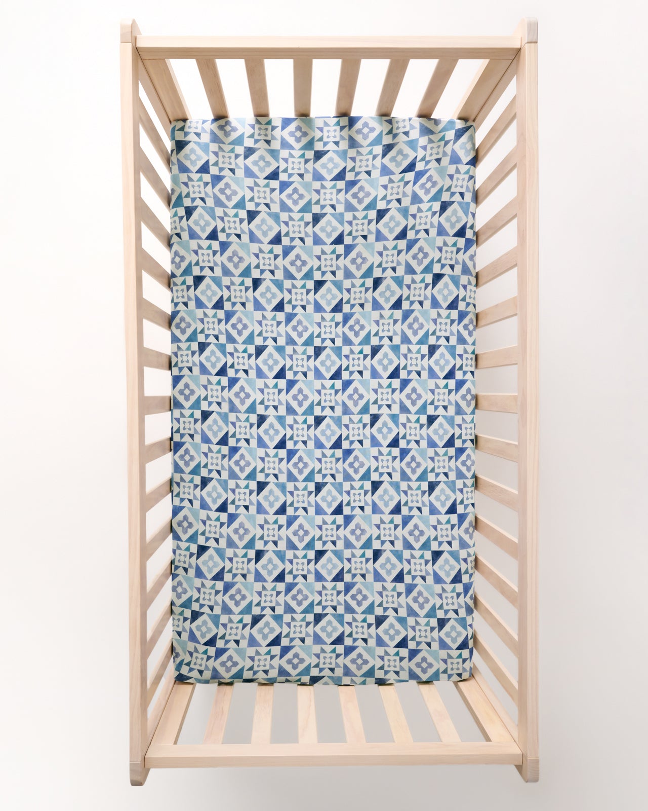 Overhead view of the Patchwork Indigo Fitted Crib Sheet