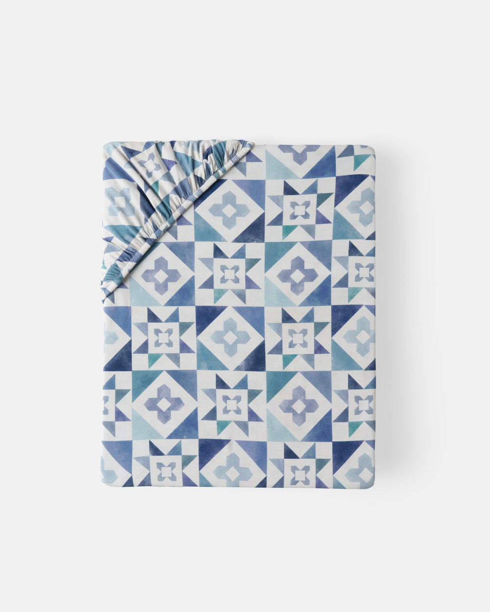 Flat lay of the Patchwork Indigo Fitted Crib Sheet