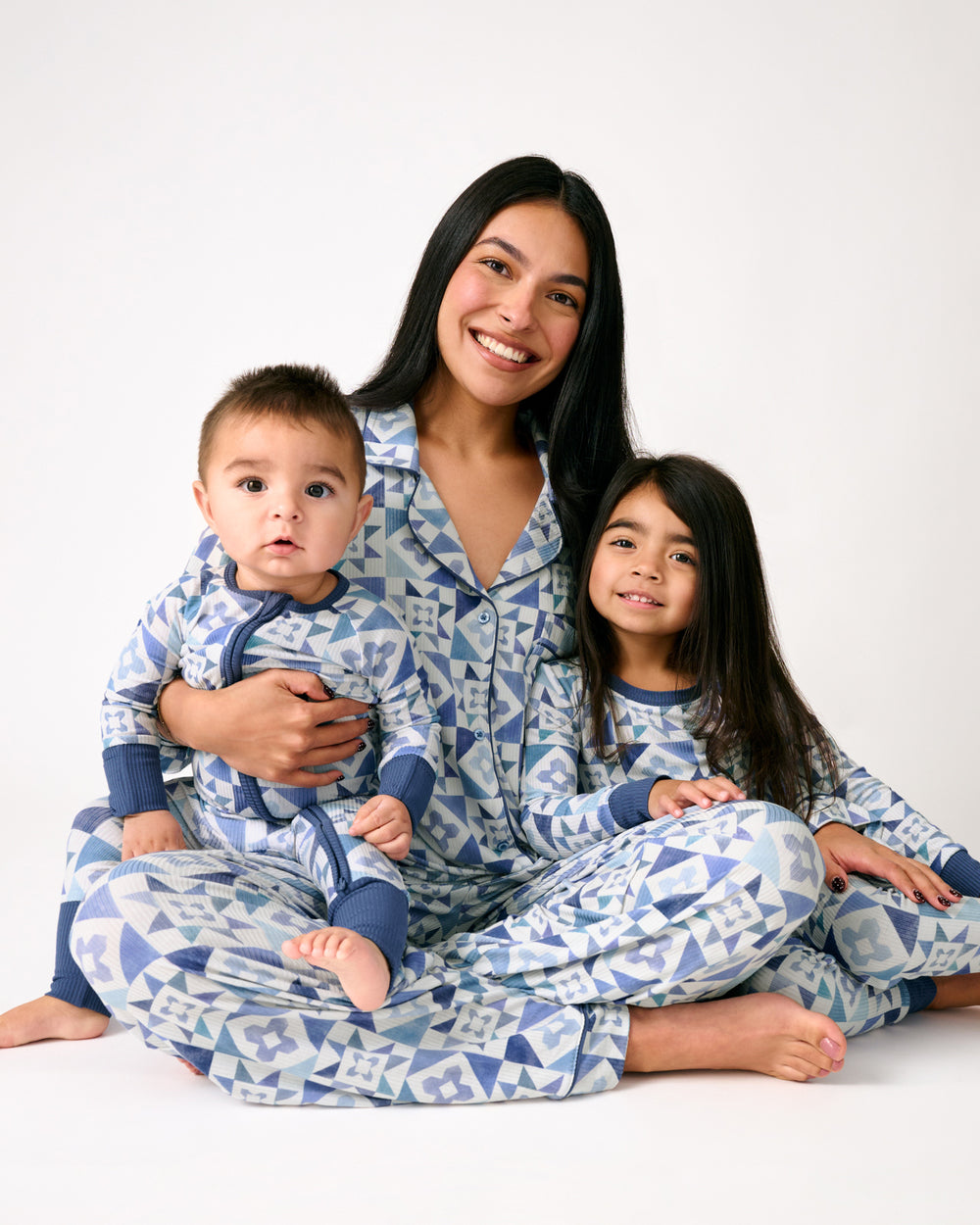 Family of three wearing matching Patchwork Indigo pajamas