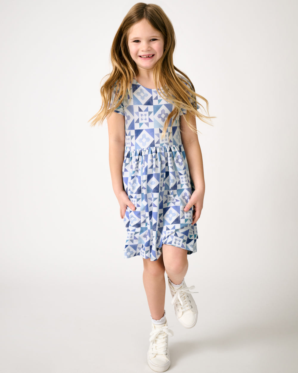 Girl in motion wearing the Patchwork Indigo Patch Pocket Dress