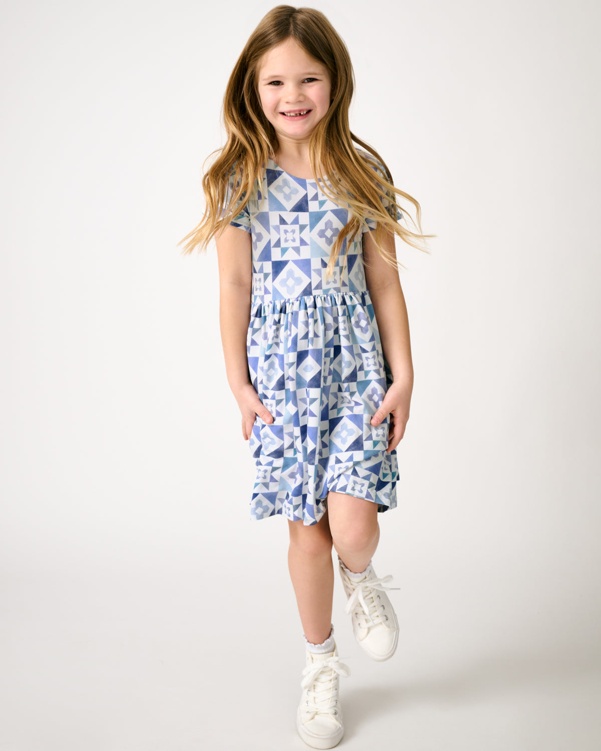 Girl in motion wearing the Patchwork Indigo Patch Pocket Dress