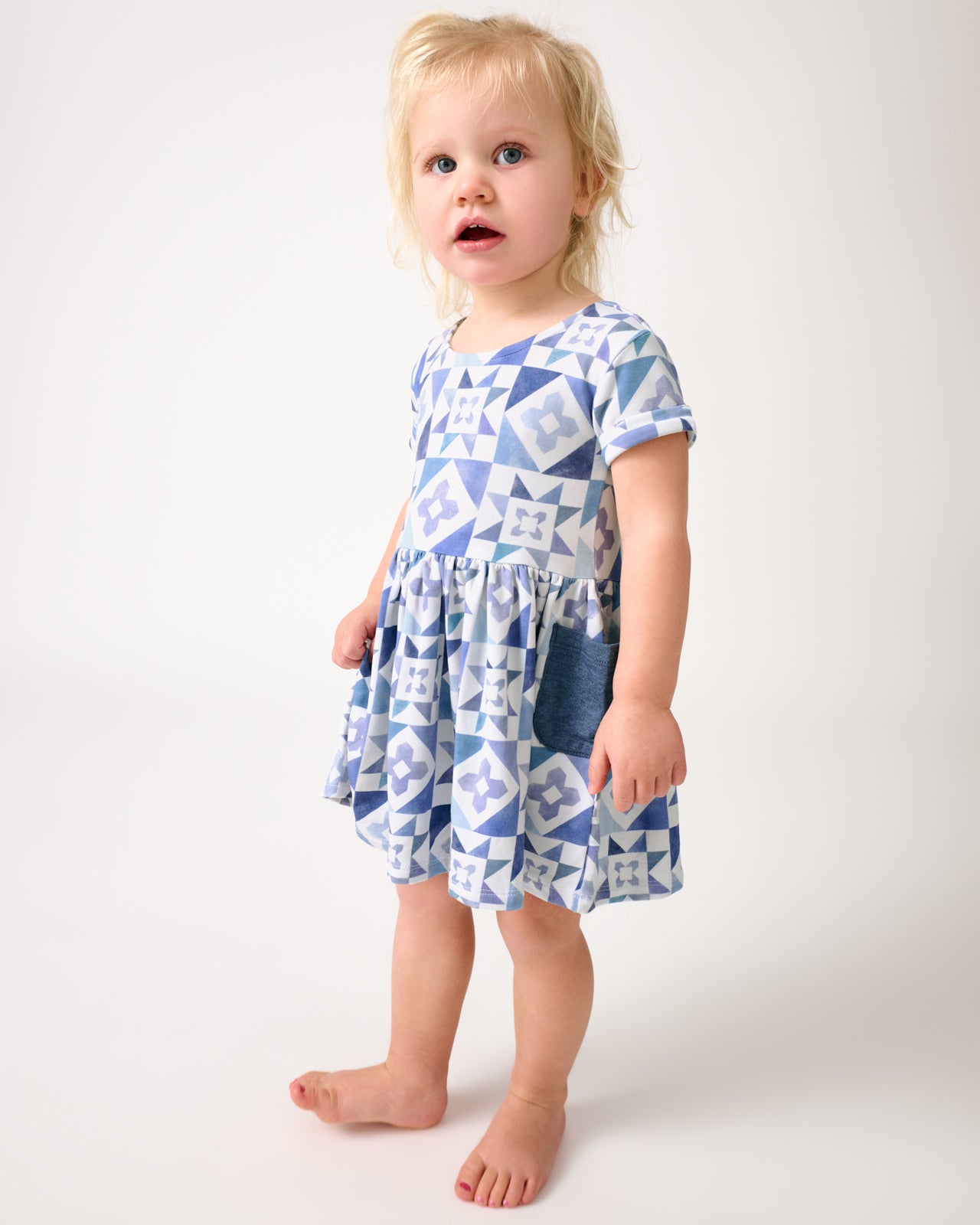 Toddler wearing the Patchwork Indigo Patch Pocket Dress with Bloomer