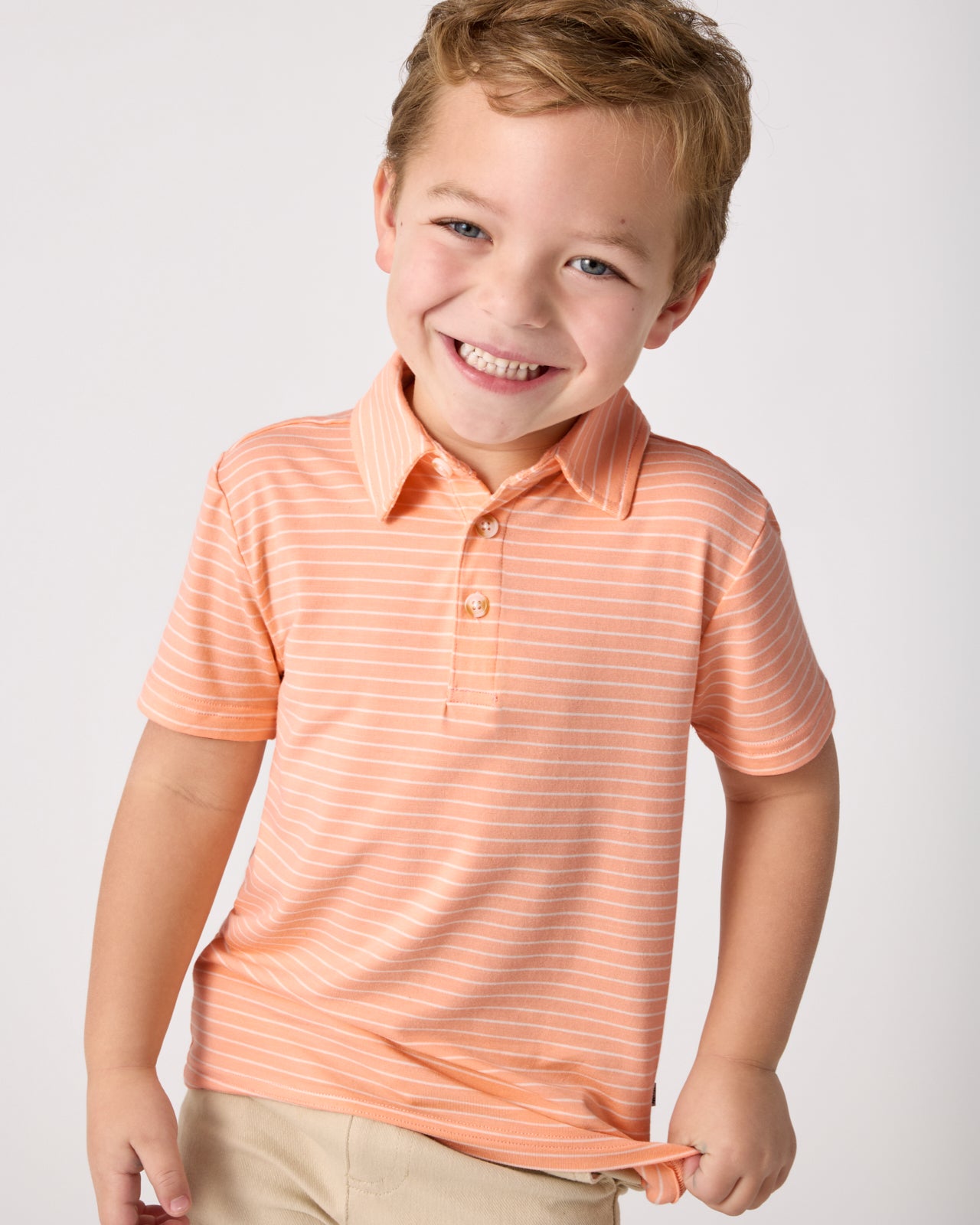 Boy wearing the Peachy Keen Stripe Polo Shirt