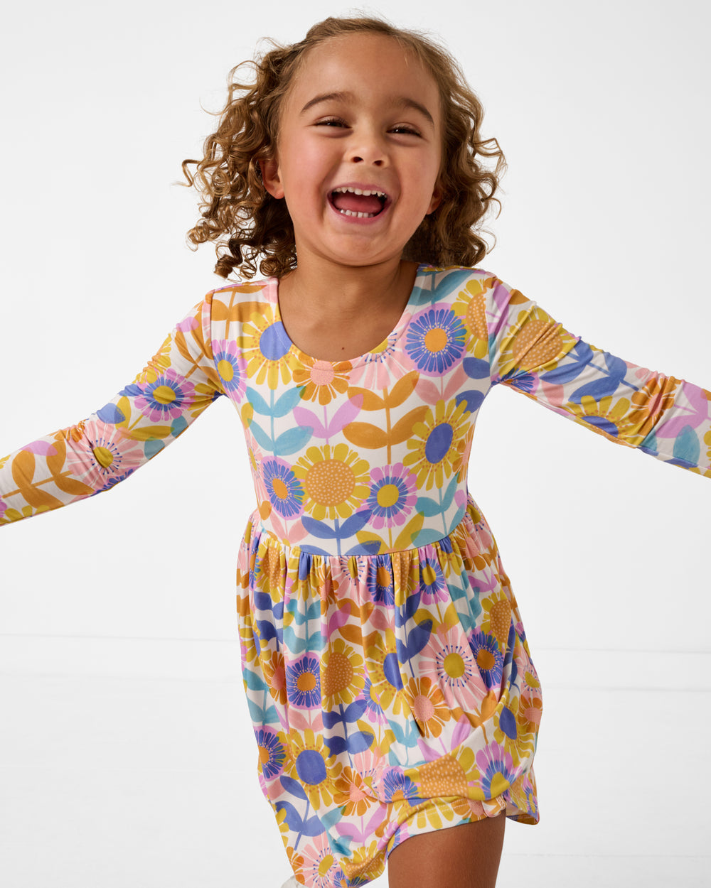 Close up of girl wearing the Petal Power Bow Back Skater Dress