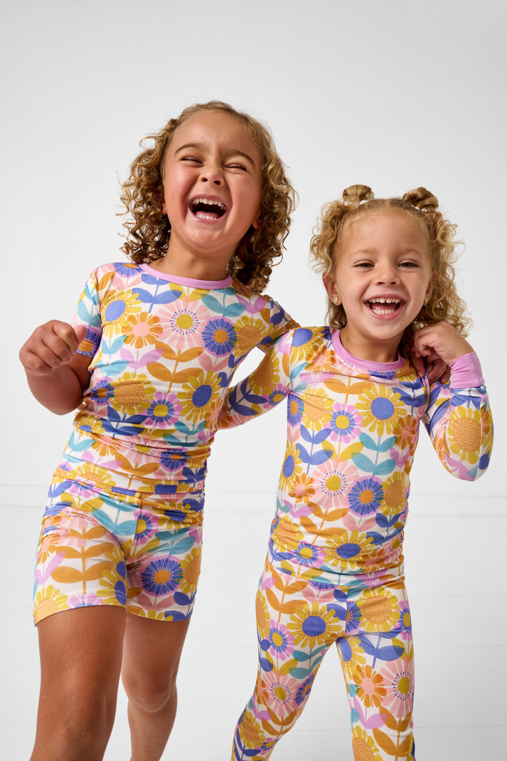 Two girls wearing the Petal Power Two-Piece Pajama Sets