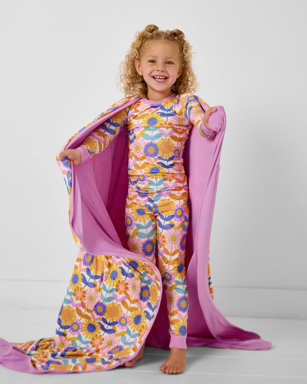 Standing girl wrapped in the Petal Power Large Cloud Blanket®