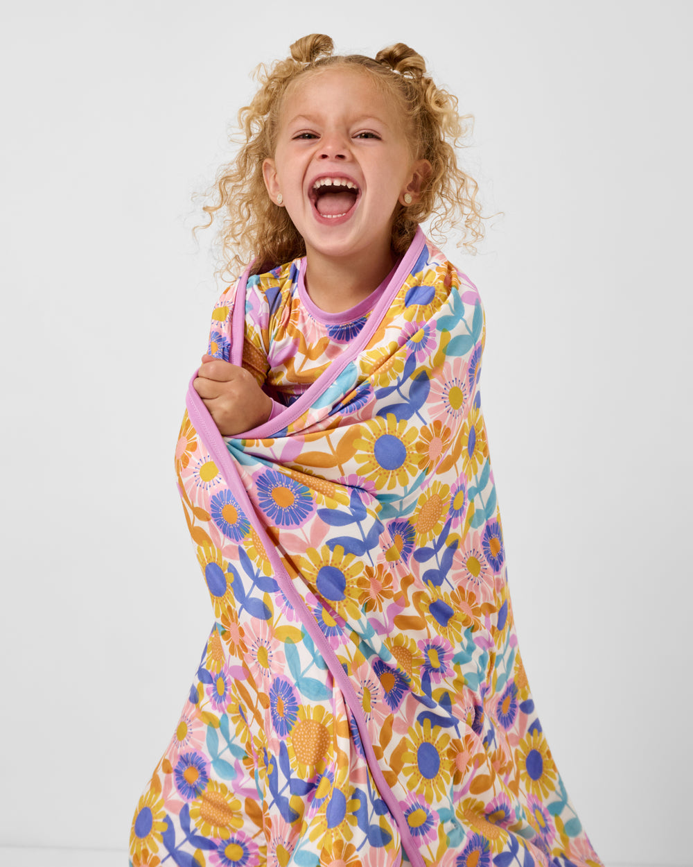 Close up of girl wearing the Petal Power Large Cloud Blanket®