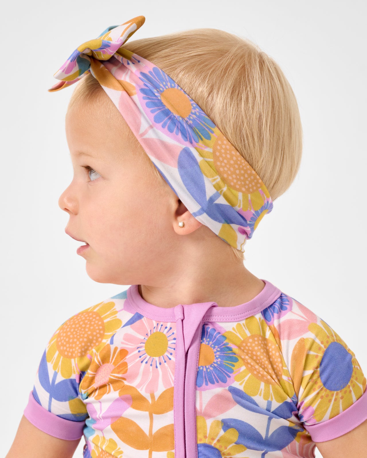 Side view of baby wearing the Petal Power Luxe Bow Headband