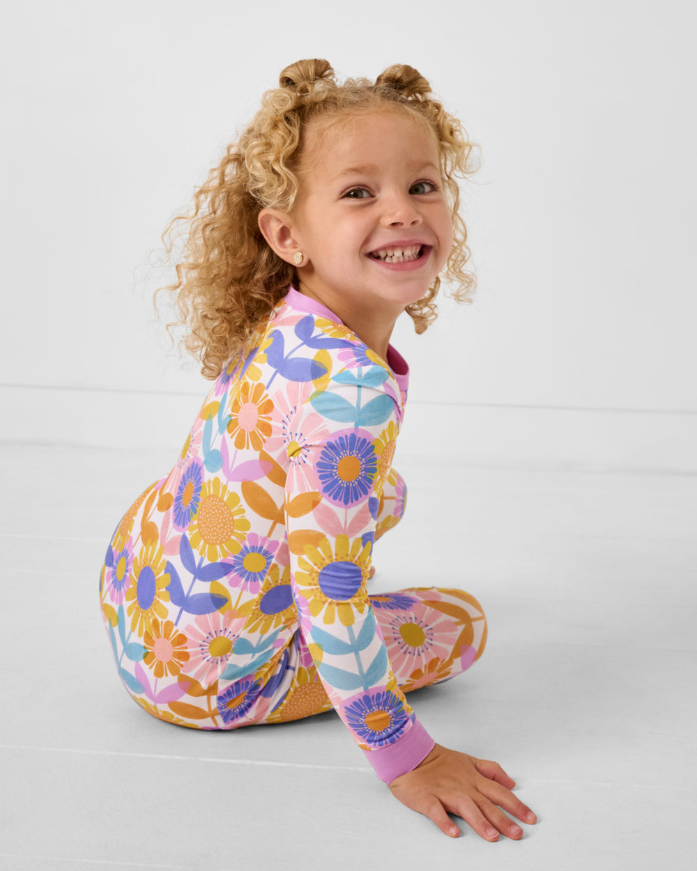 Sitting girl wearing the Petal Power Two-Piece Pajama Set