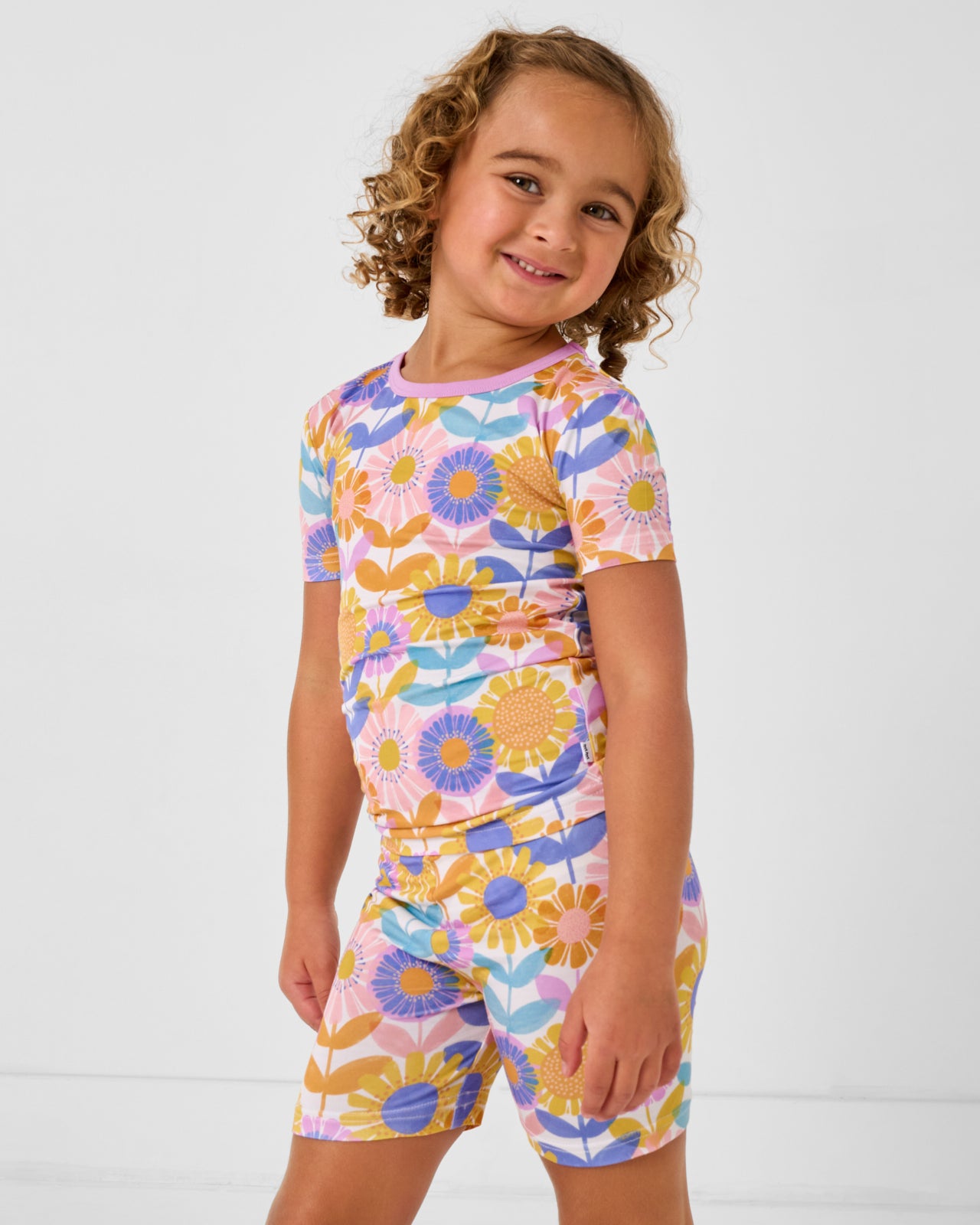 Close up of girl wearing the Petal Power Two-Piece Short Sleeve & Shorts Pajama Set