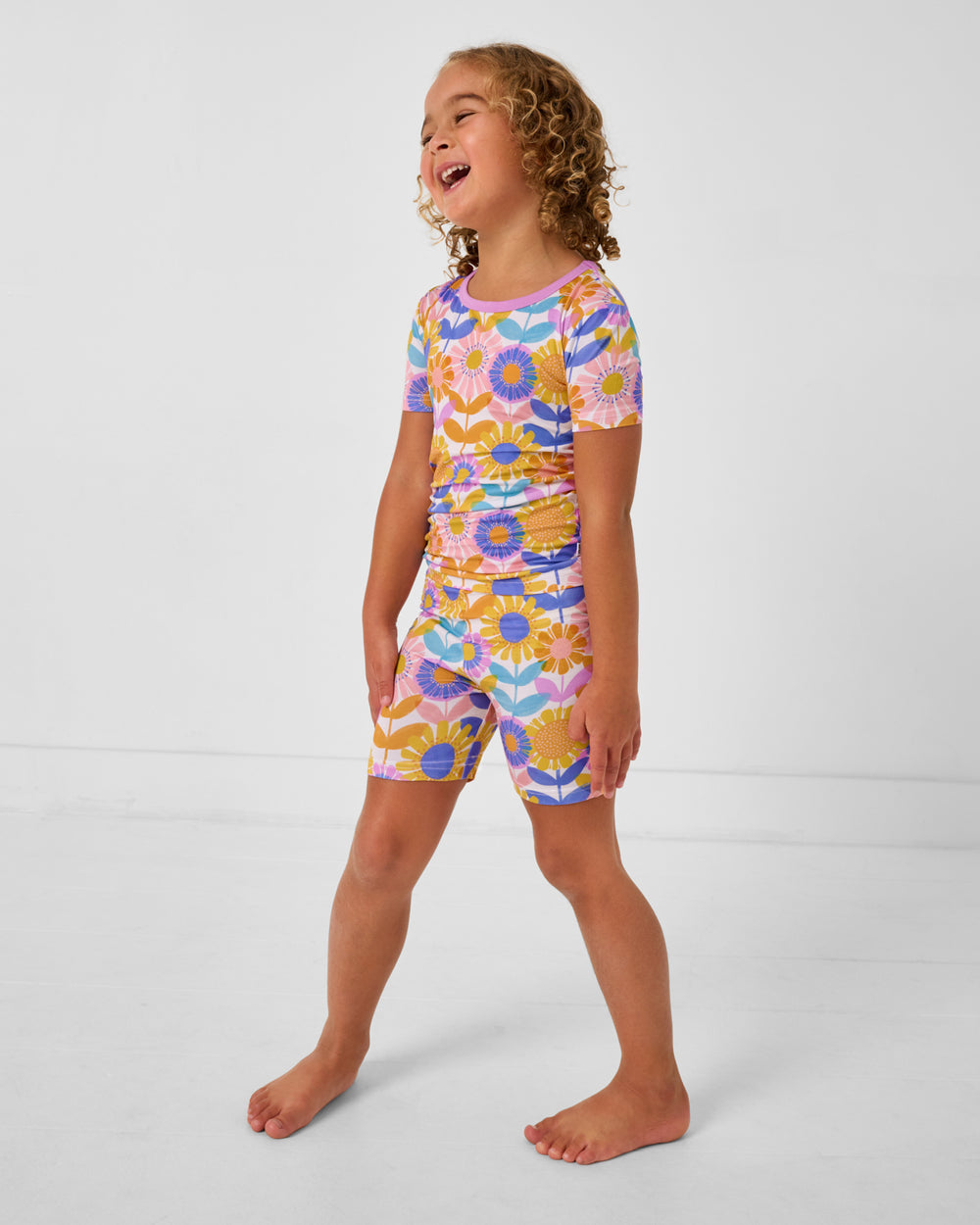 Child wearing the Petal Power Two-Piece Short Sleeve & Shorts Pajama Set