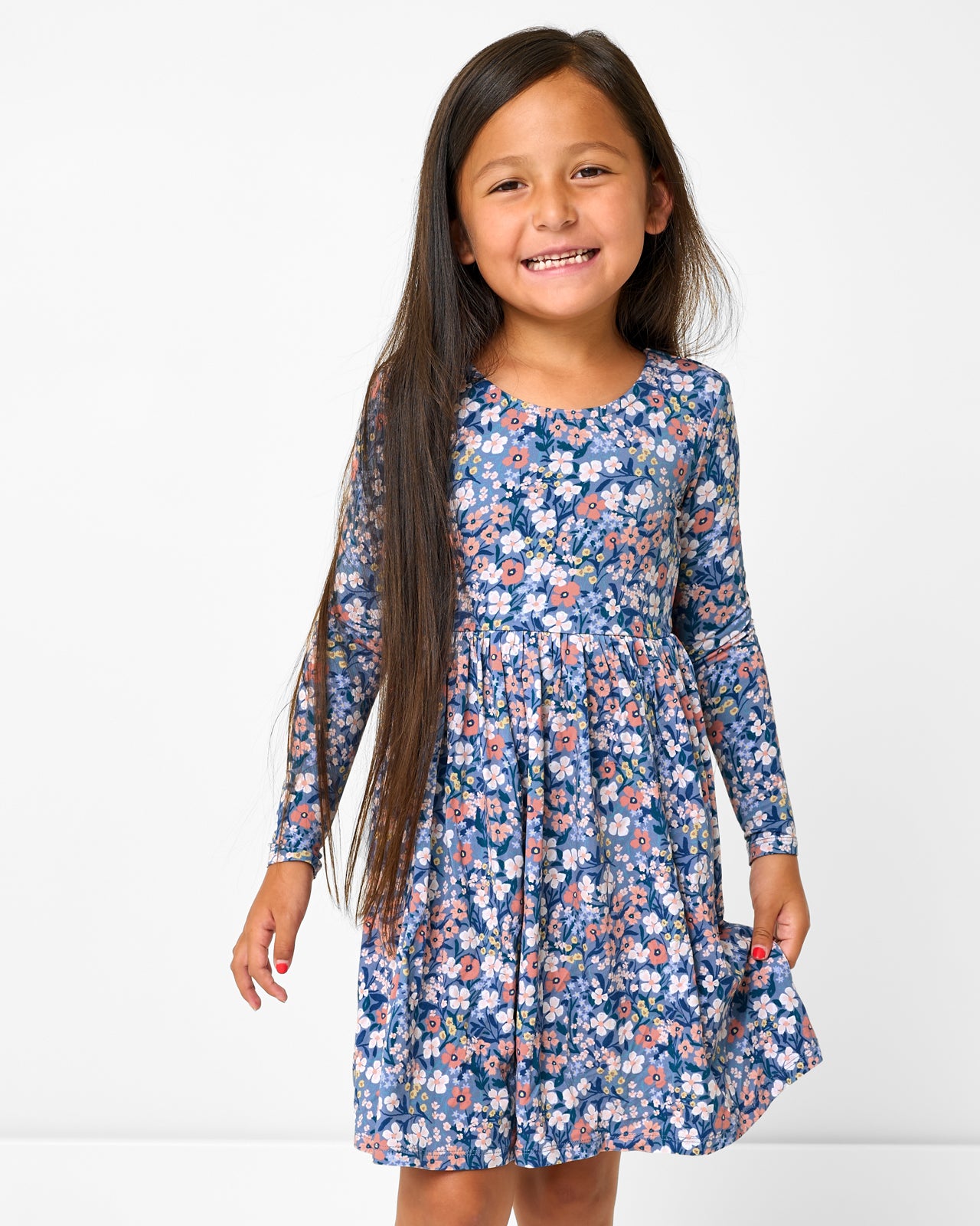 Girl wearing the Petite Petals Bow Back Skater Dress