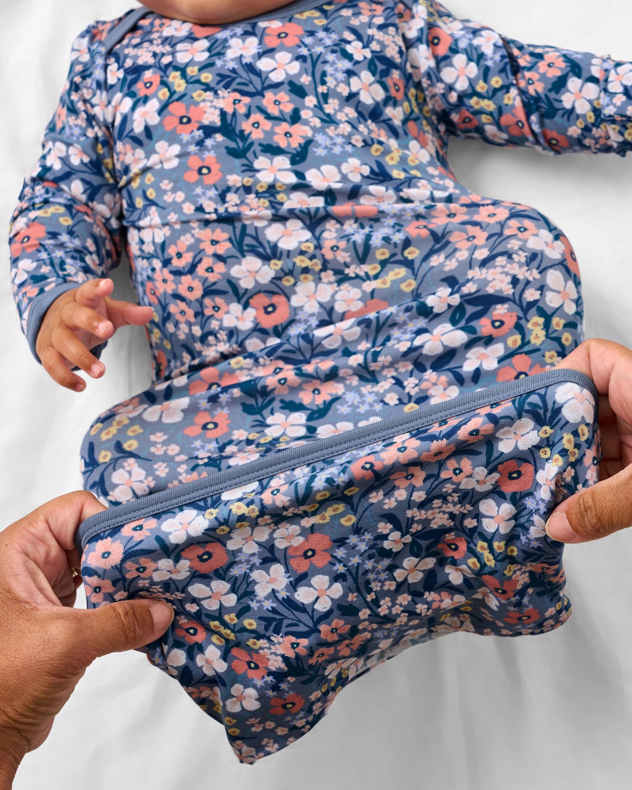 Adult demonstrating the envelope sweep on the Petite Petals Infant Gown
