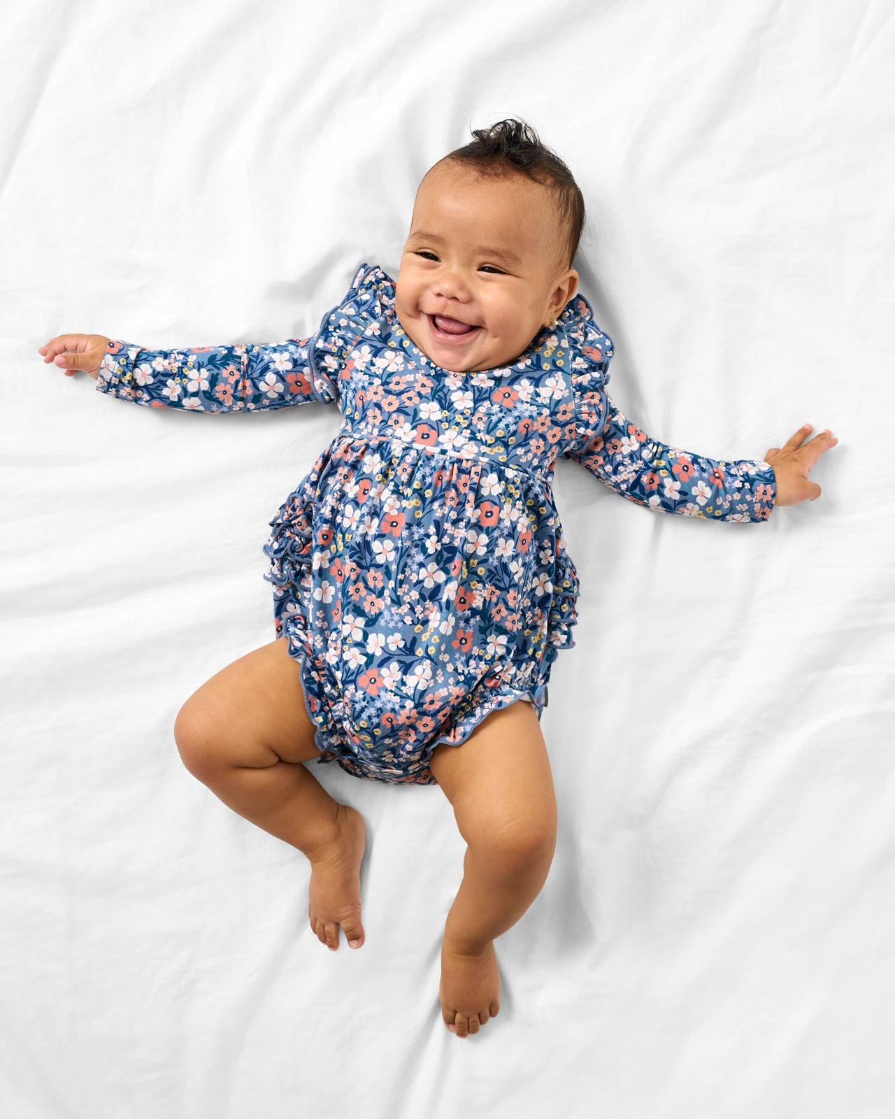 Aerial view of baby wearing the Petite Petals Bubble Romper