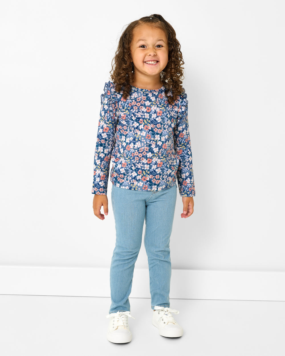 Girl wearing the Petite Petals Flutter Tee with denim pants