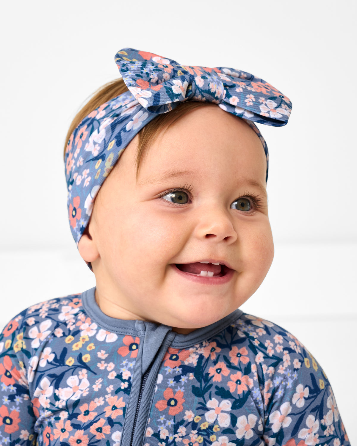 Close up of baby wearing the Petite Petals Luxe Bow Headband
