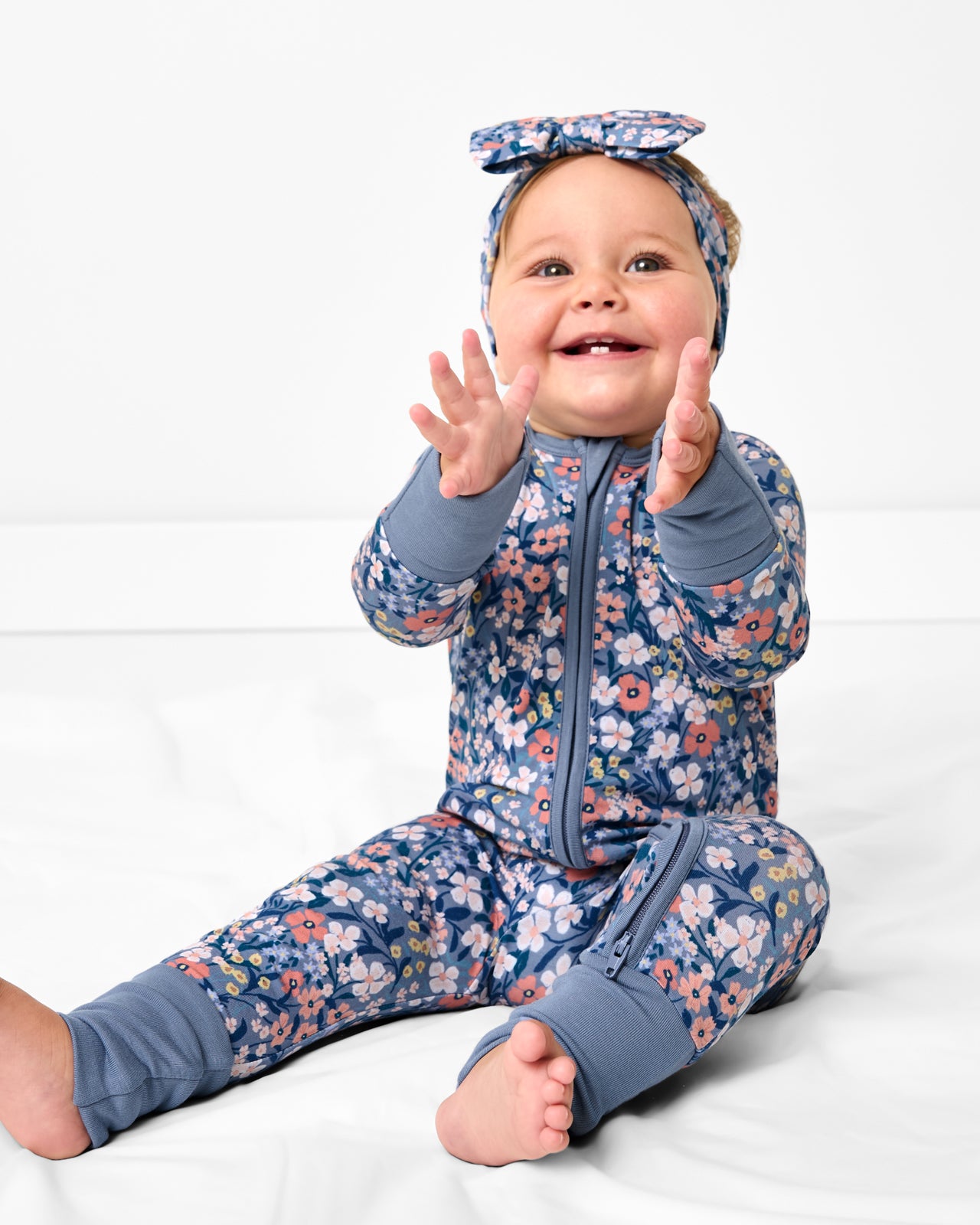 Sitting baby wearing the Petite Petals Luxe Bow Headband