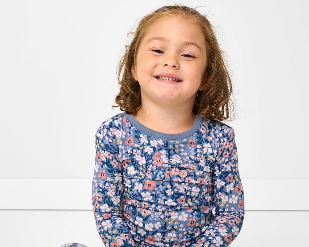 Sitting girl wearing the Petite Petals Two-Piece Pajama Set