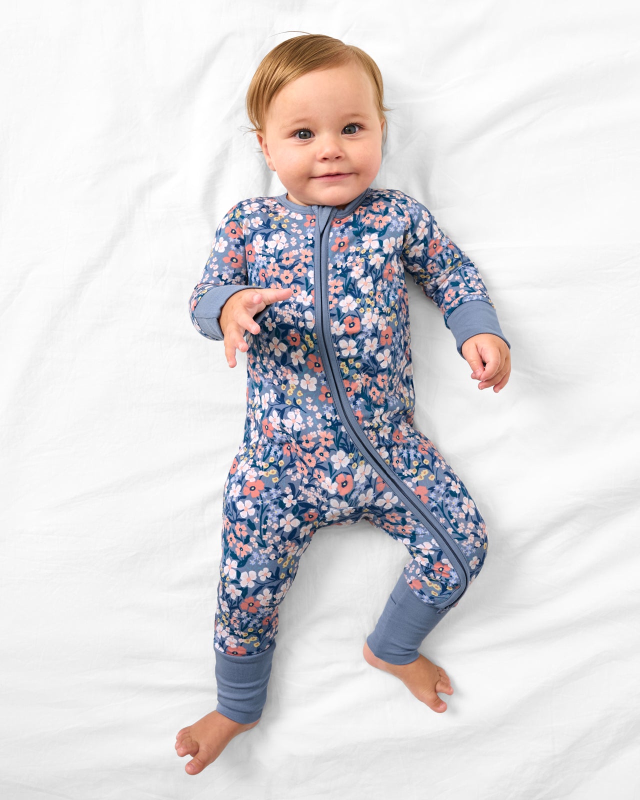 Aerial view of baby wearing the Petite Petals Zippy