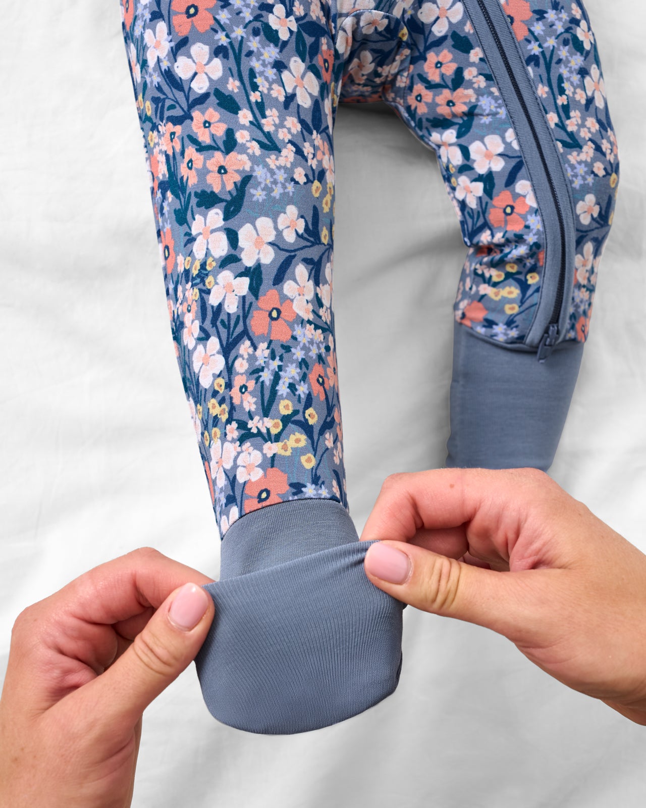 Adult demonstrating the foot fold-over feature on the Petite Petals Zippy