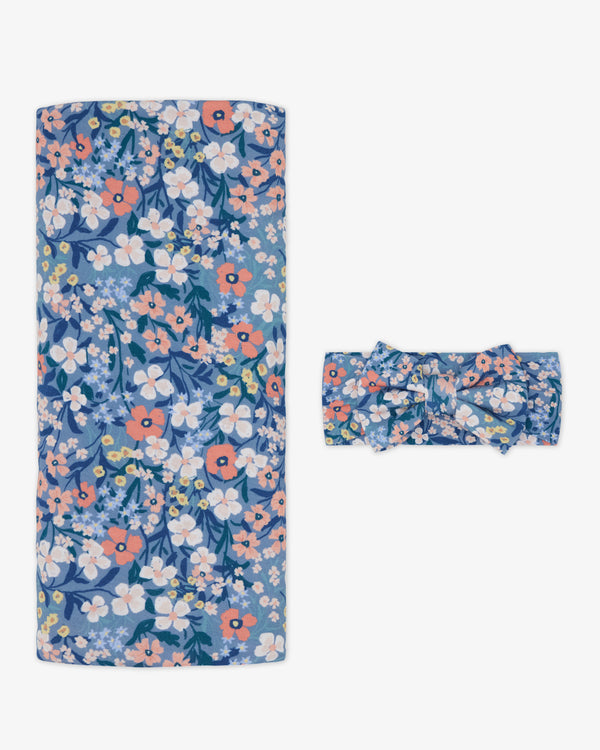 Flat lay of the Petite Petals Swaddle & Luxe Bow Headband Set