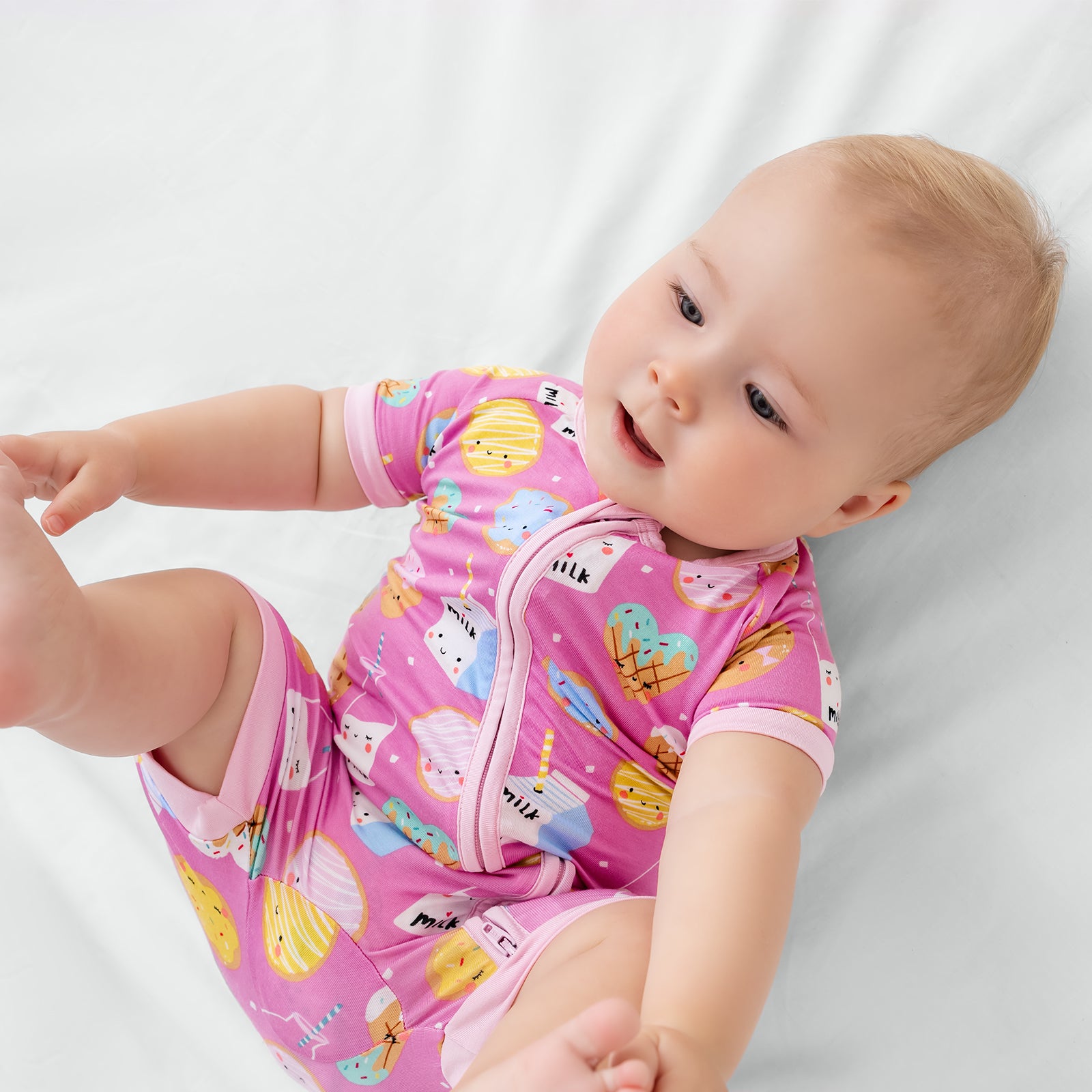 Close up of baby wearing the Pink Cookies & Milk Shorty Zippy
