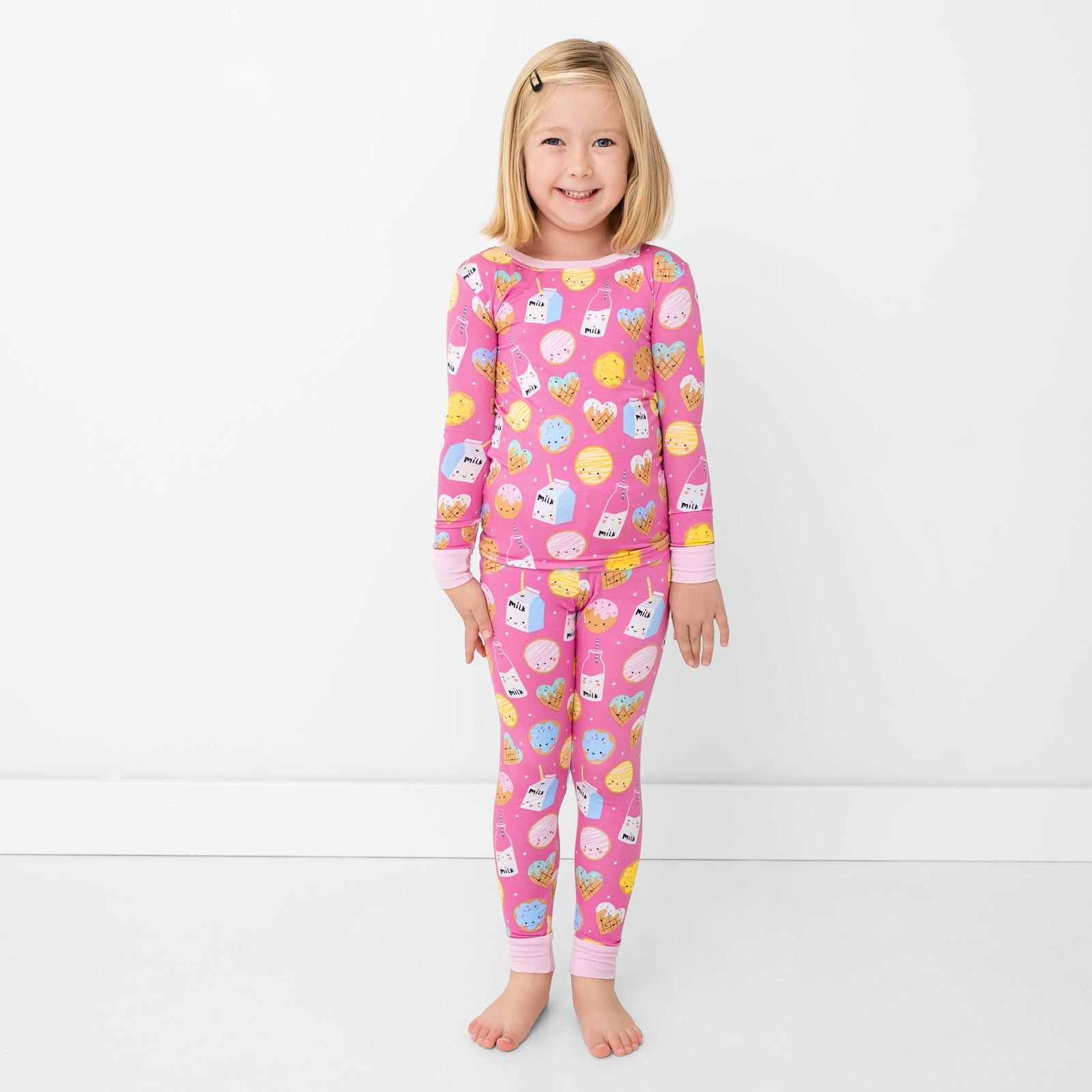 Standing child wearing the Pink Cookies & Milk Two-Piece Pajama Set