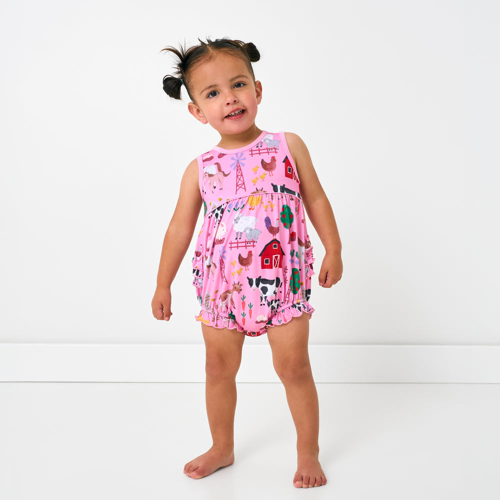 Standing toddler wearing the Pink Farm Fam Bubble Romper