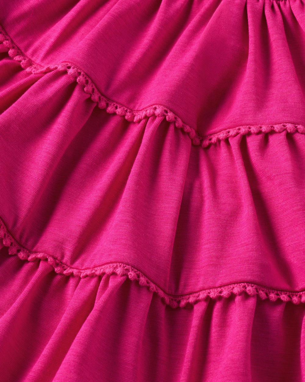 Close up of the tiered detail on the Pink Punch Open Back Tiered Dress with Bloomer