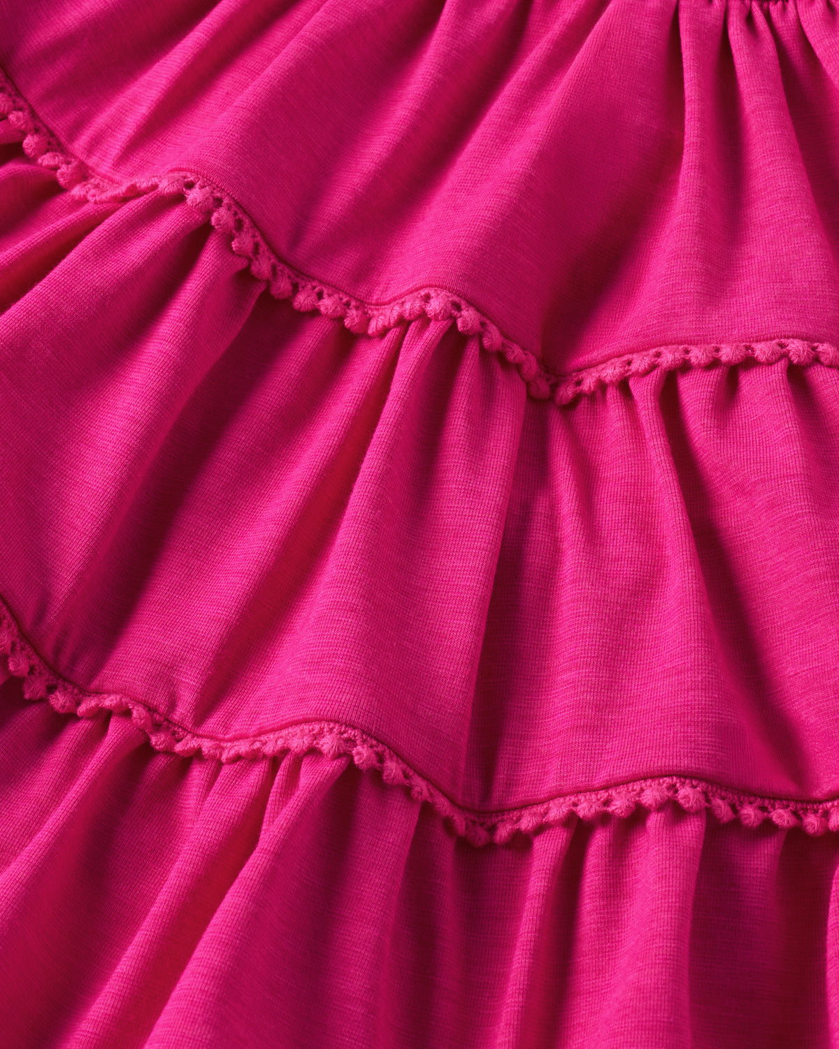 Close up of the tiered detail on the Pink Punch Open Back Tiered Dress with Bloomer