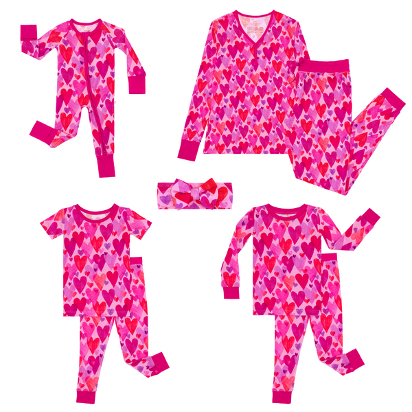 flat lay composite of a pink hearts & crafts zippy, two-piece pajama set, two-piece short sleeve pajama set, luxe bow headband, and women's pajamas