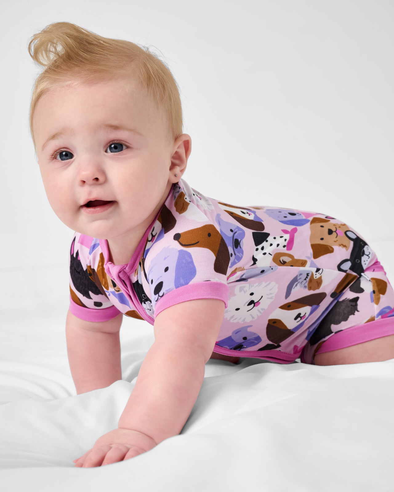 Crawling baby wearing the Pink Puppy Parade Shorty Zippy