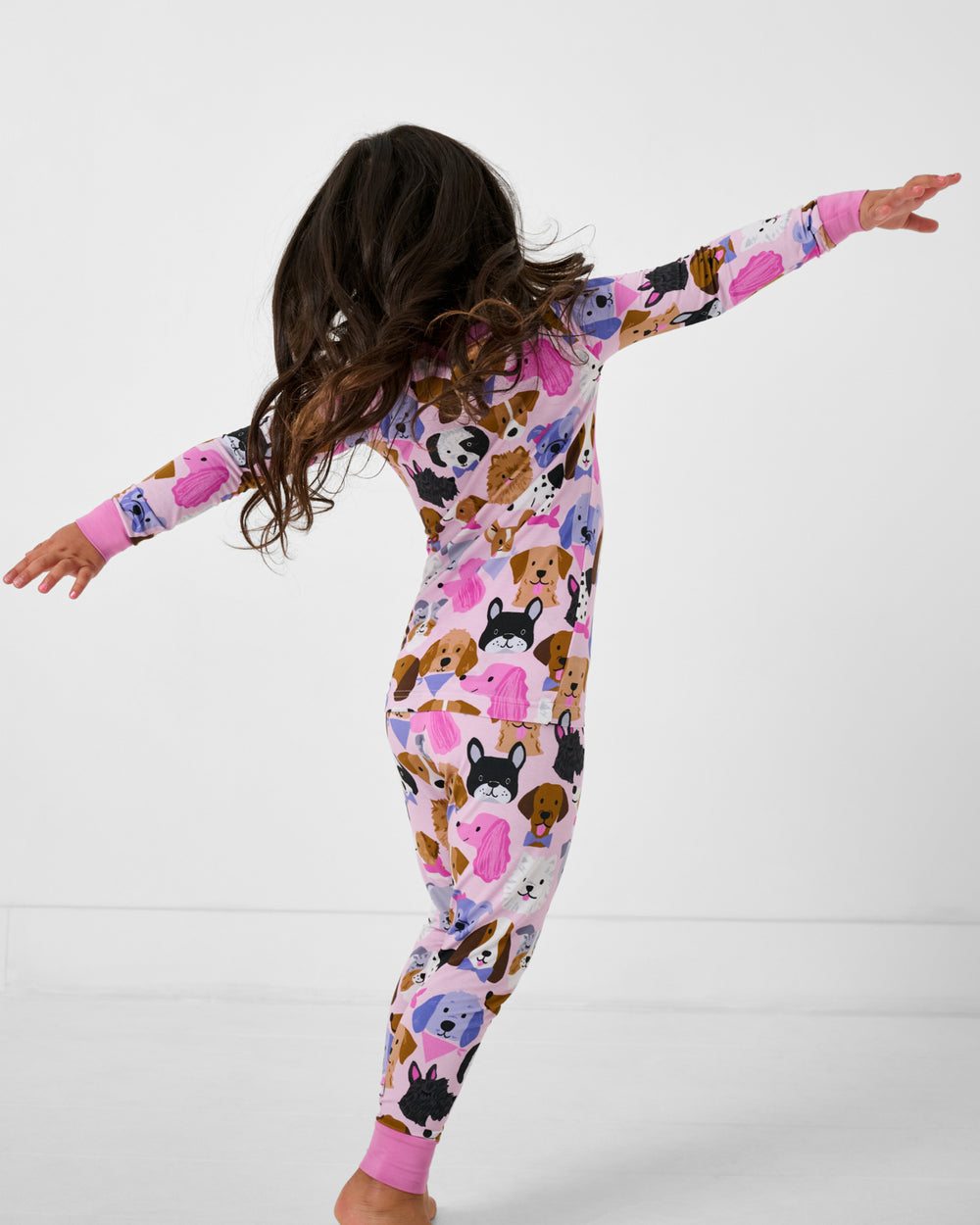 Posing girl wearing the Pink Puppy Parade Two-Piece Pajama Set