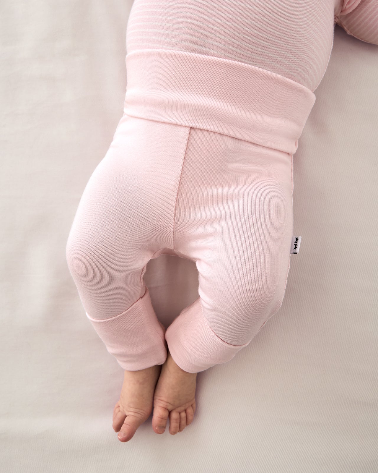 Newborn baby wearing the Prima Pink Fold Over Legging
