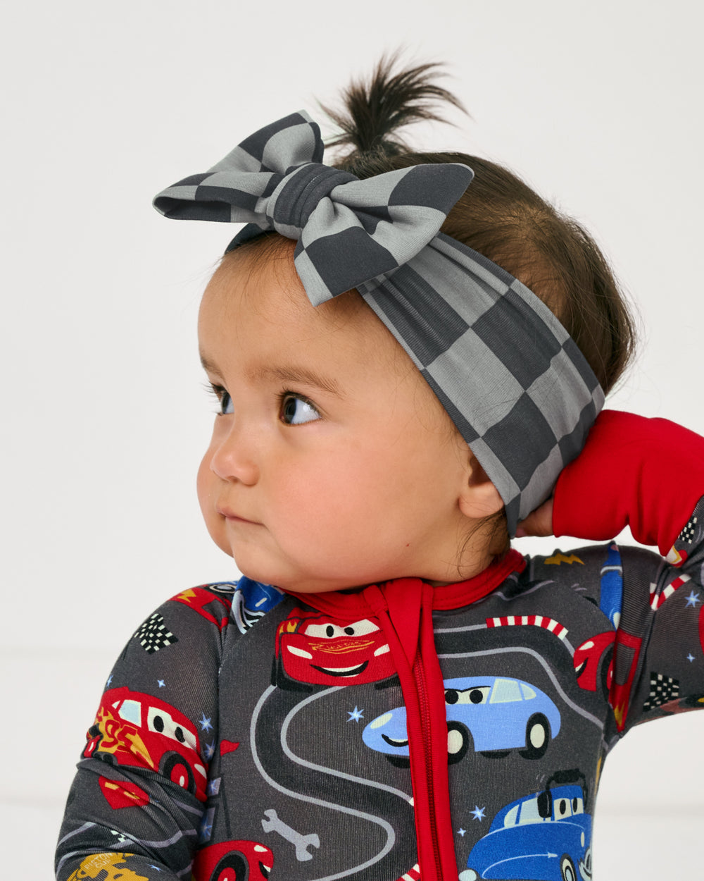 Alternate close up of baby wearing the  Luxe Bow Headband in the disney cars collection