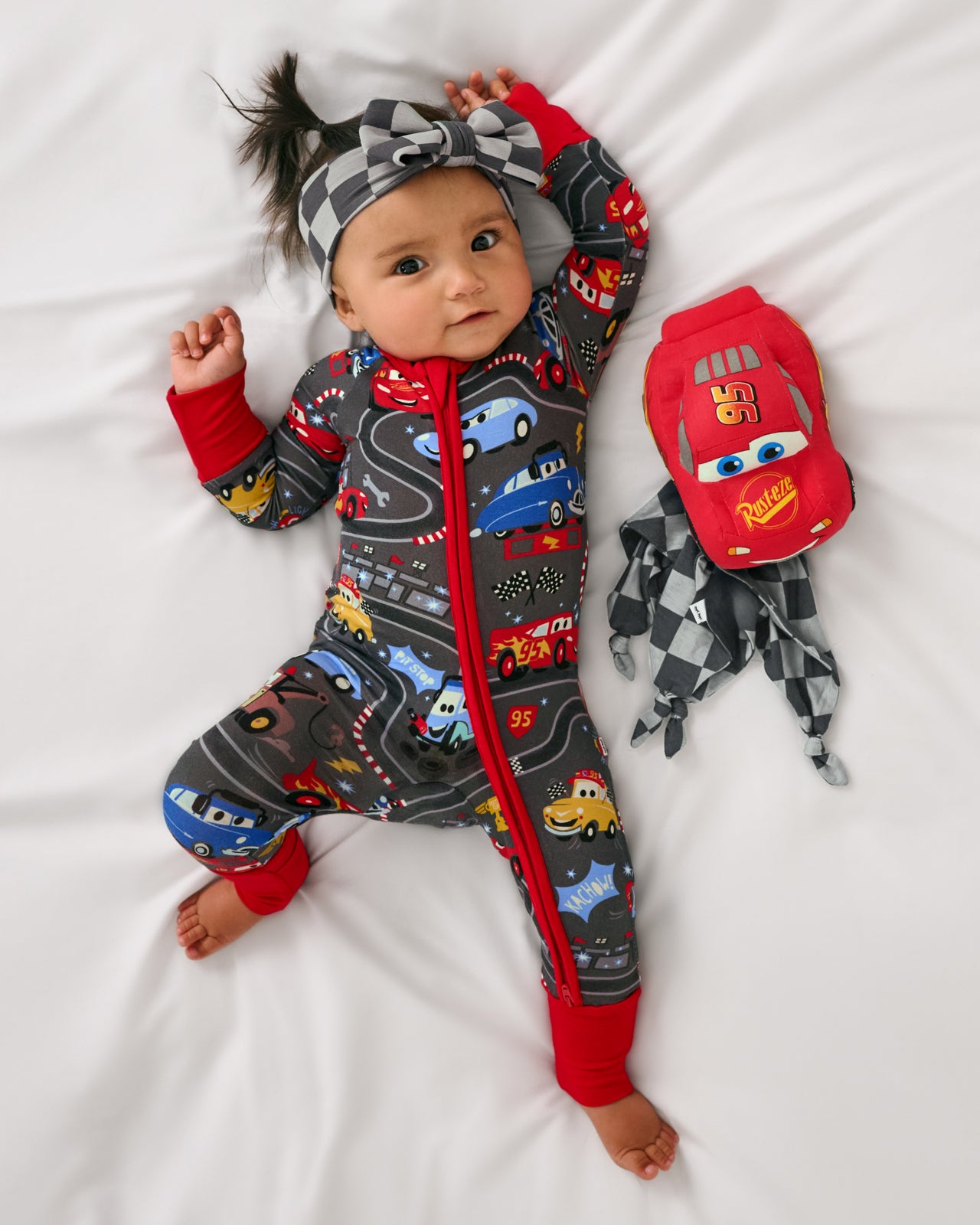 Aerial view of baby laying with the Disney & Pixar Lightning McQueen Lovey