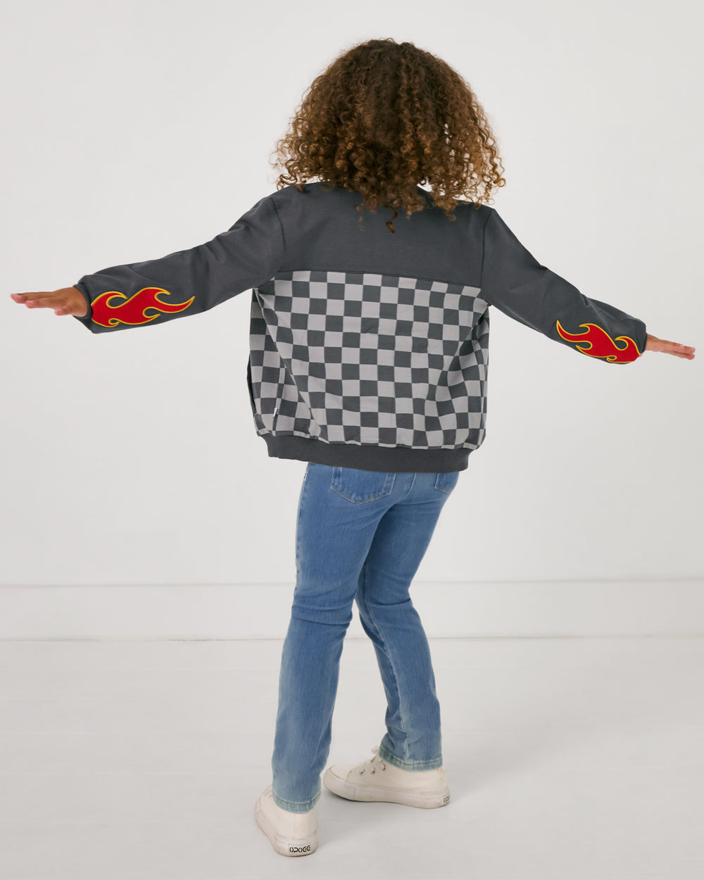 Back view of girl wearing the Disney & Pixar Piston Cup Bomber Jacket