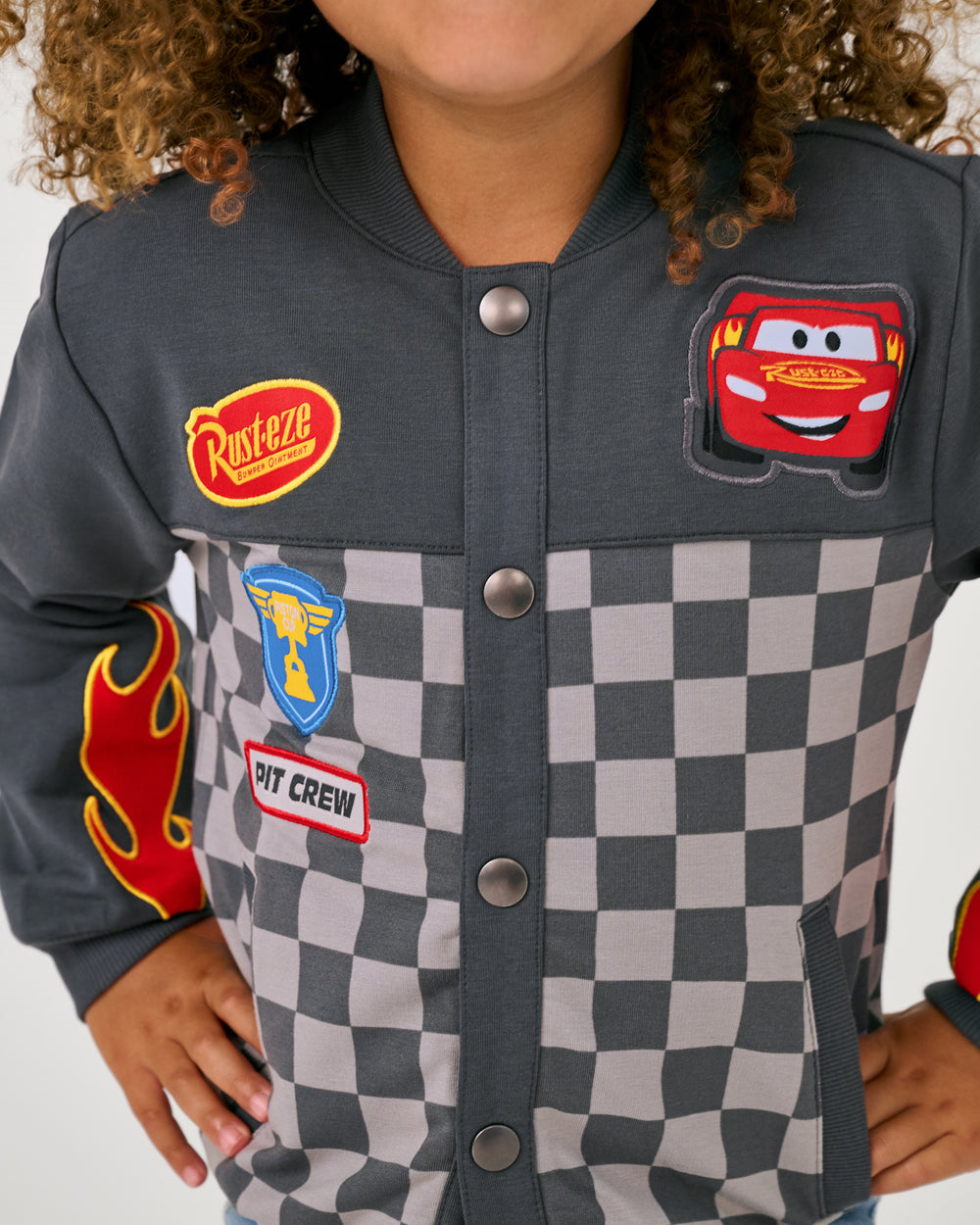 Close up of the patch details on the Disney & Pixar Piston Cup Bomber Jacket