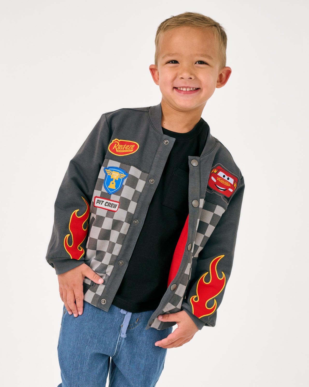 Boy wearing the Disney & Pixar Piston Cup Bomber Jacket and denim joggers