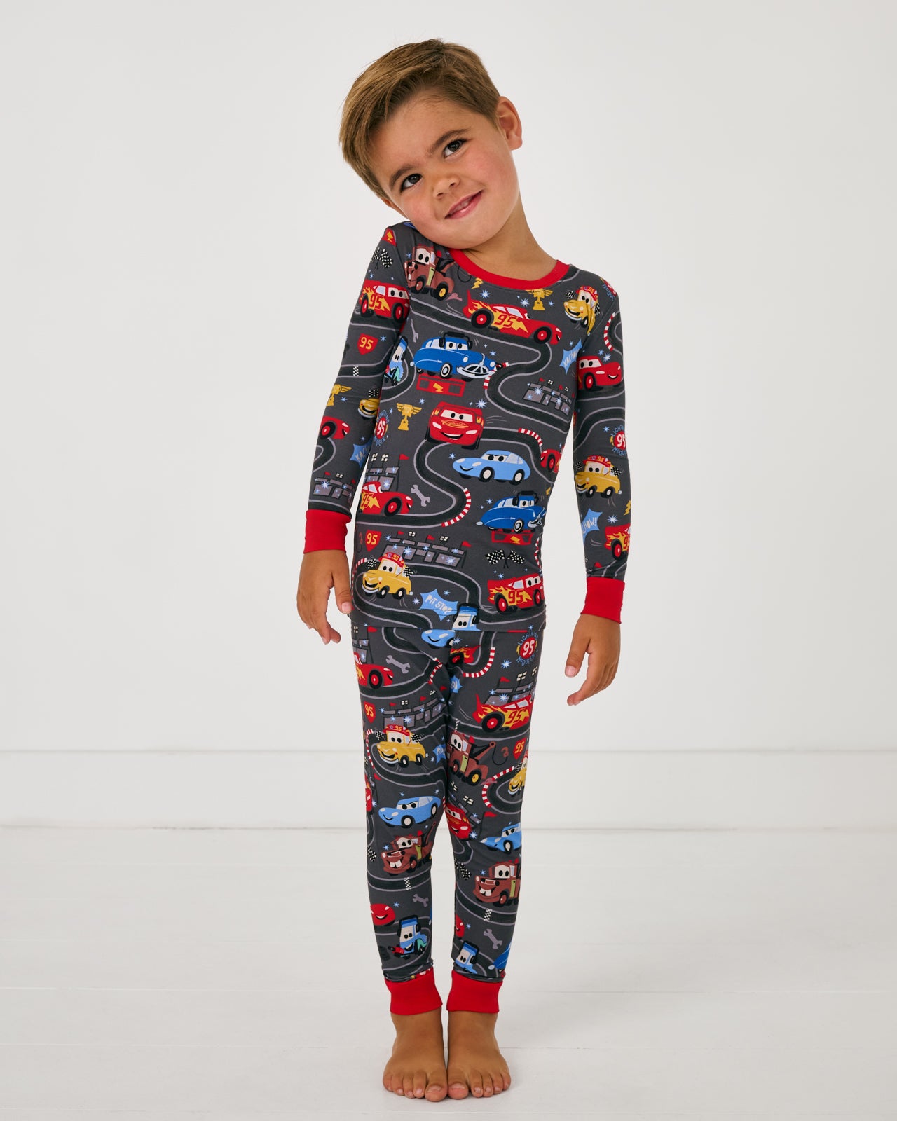  Boy wearing the Disney & Pixar Piston Cup Two-Piece Pajama Set
