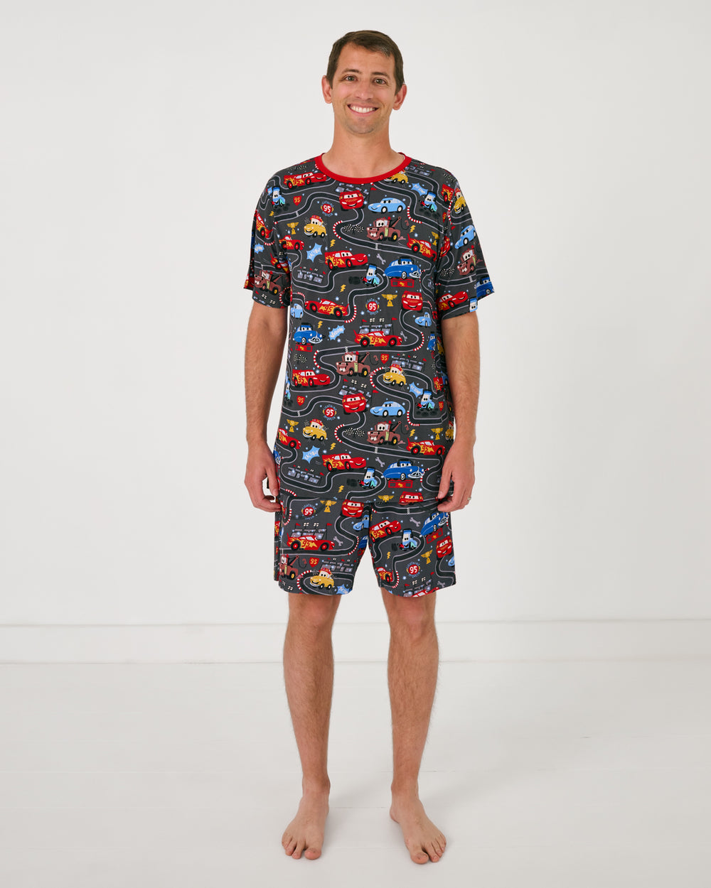 Man wearing the Disney & Pixar Piston Cup Men's Pajama Shorts and matching shirt