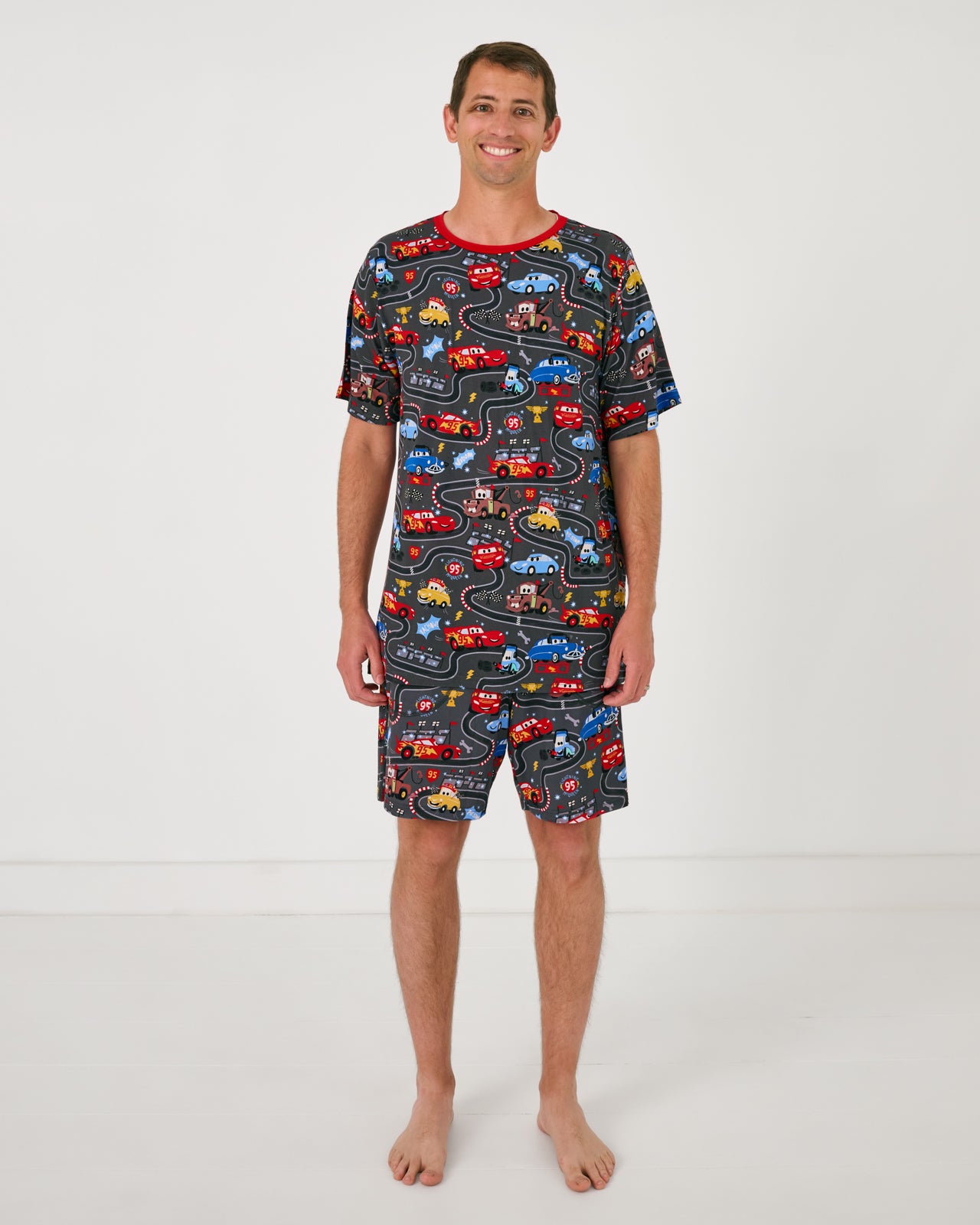 Man wearing the Disney & Pixar Piston Cup Men's Pajama Shorts and matching shirt
