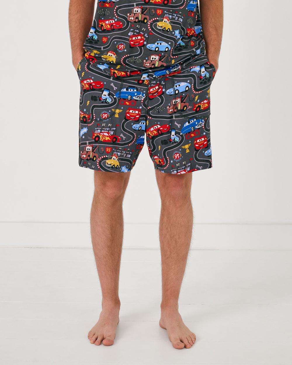 Man wearing the Disney & Pixar Piston Cup Men's Pajama Shorts