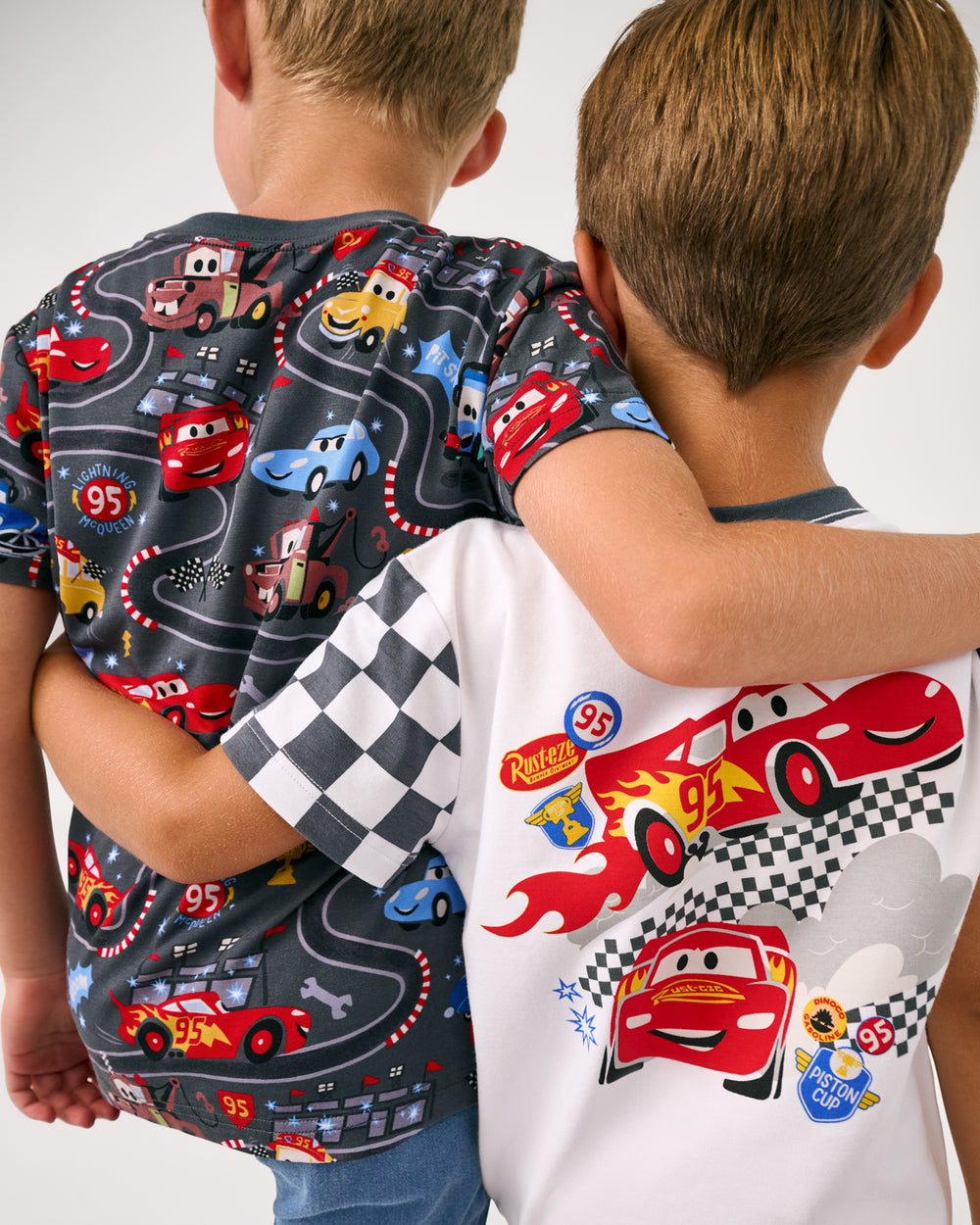 Back view of two boys wearing tshirts from the Disney Cars collection