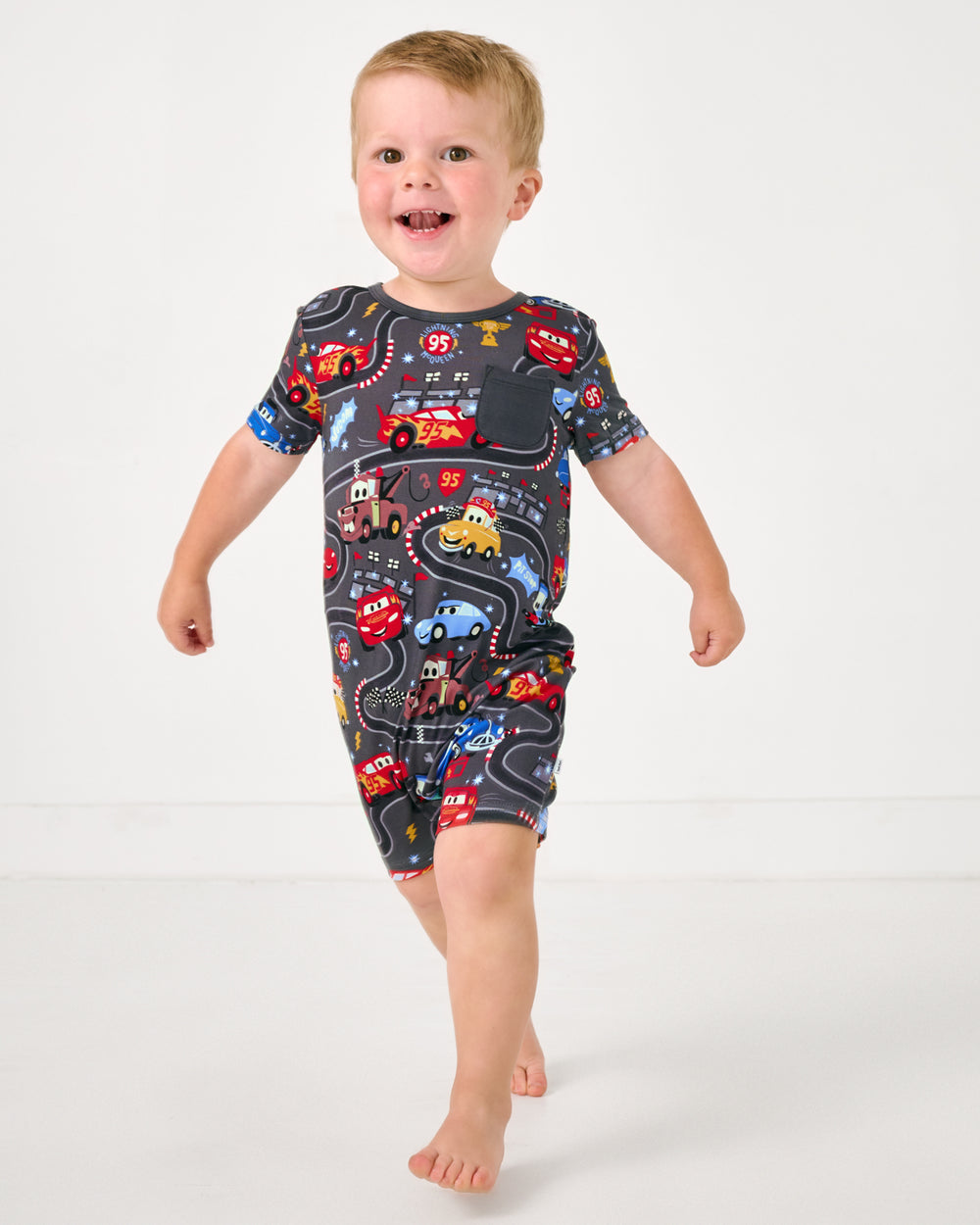 Alternate child wearing the Disney & Pixar Piston Cup Pocket Shorty Romper