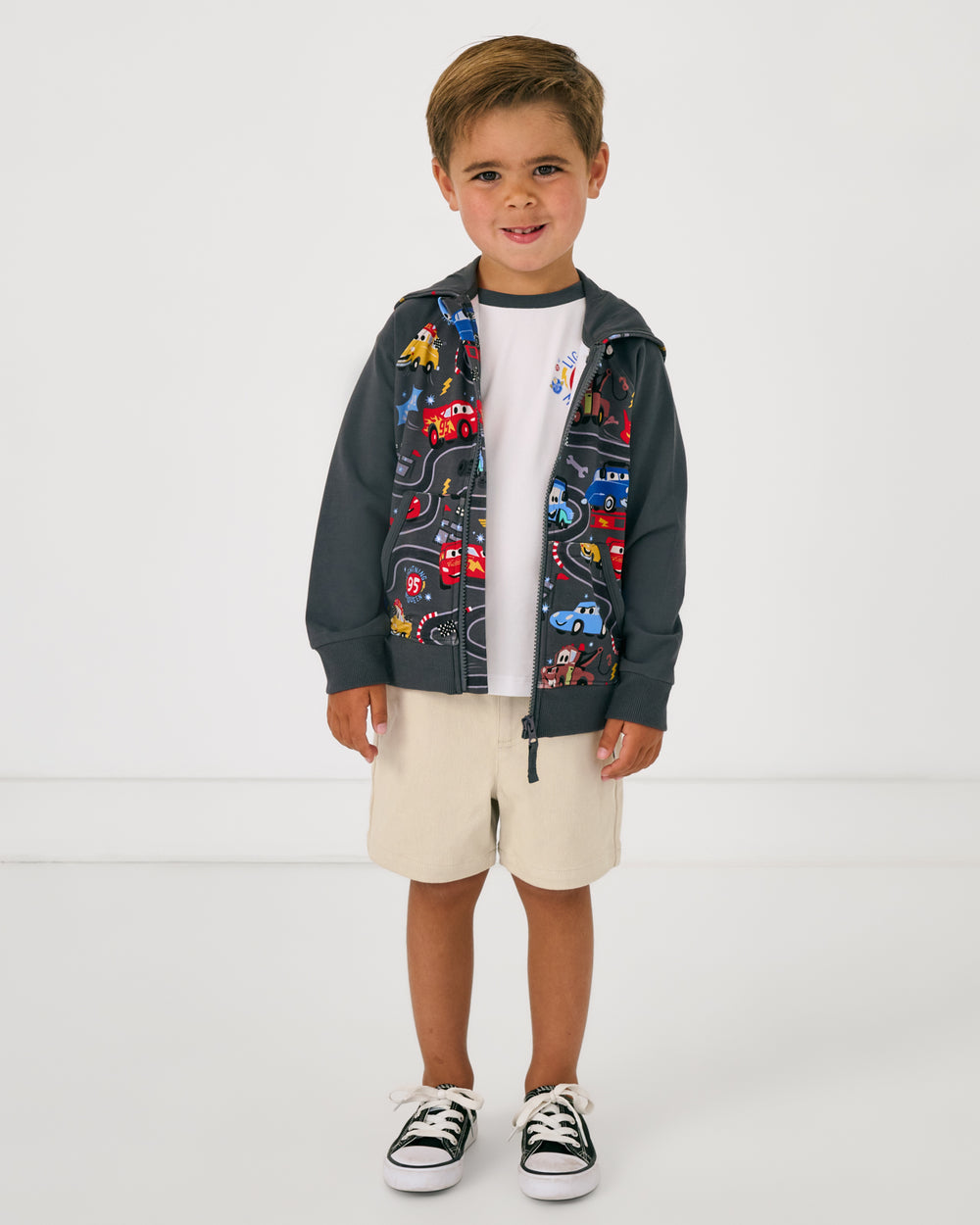 Alternate of boy wearing the Disney & Pixar Piston Cup Zip Hoodie layered over the Cars themed tee