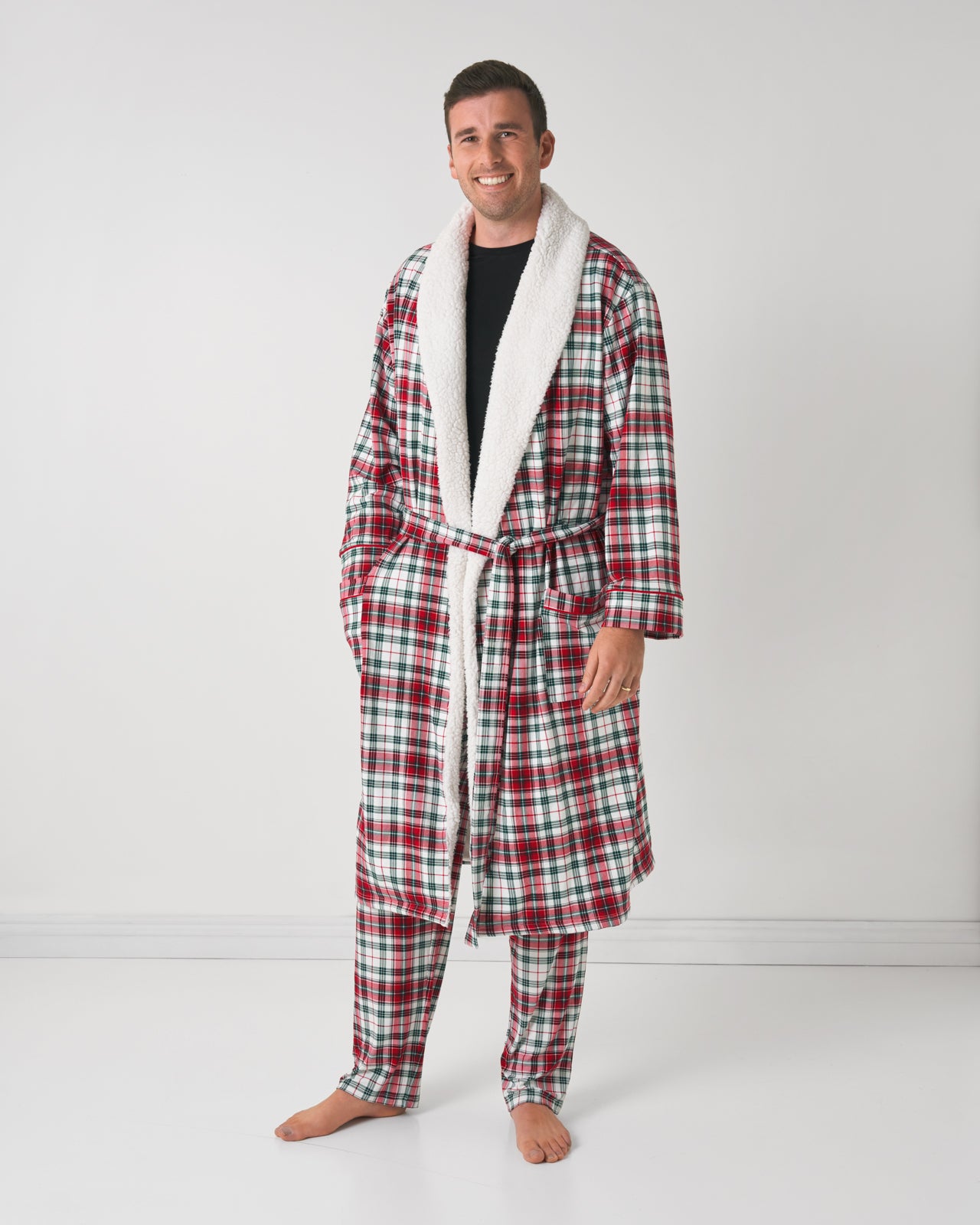 Man standing wearing the Holly Plaid Czy Robe with one hand in his pocket.