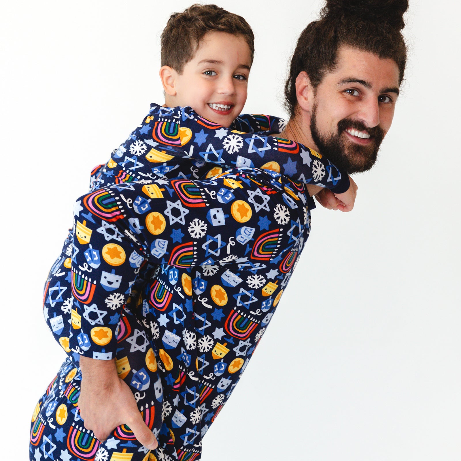 Father and son wearing matching Playful Dreidels pajamas