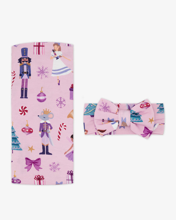 Flat lay of the Nutcracker Ballet Swaddle & Luxe Bow Headband Set